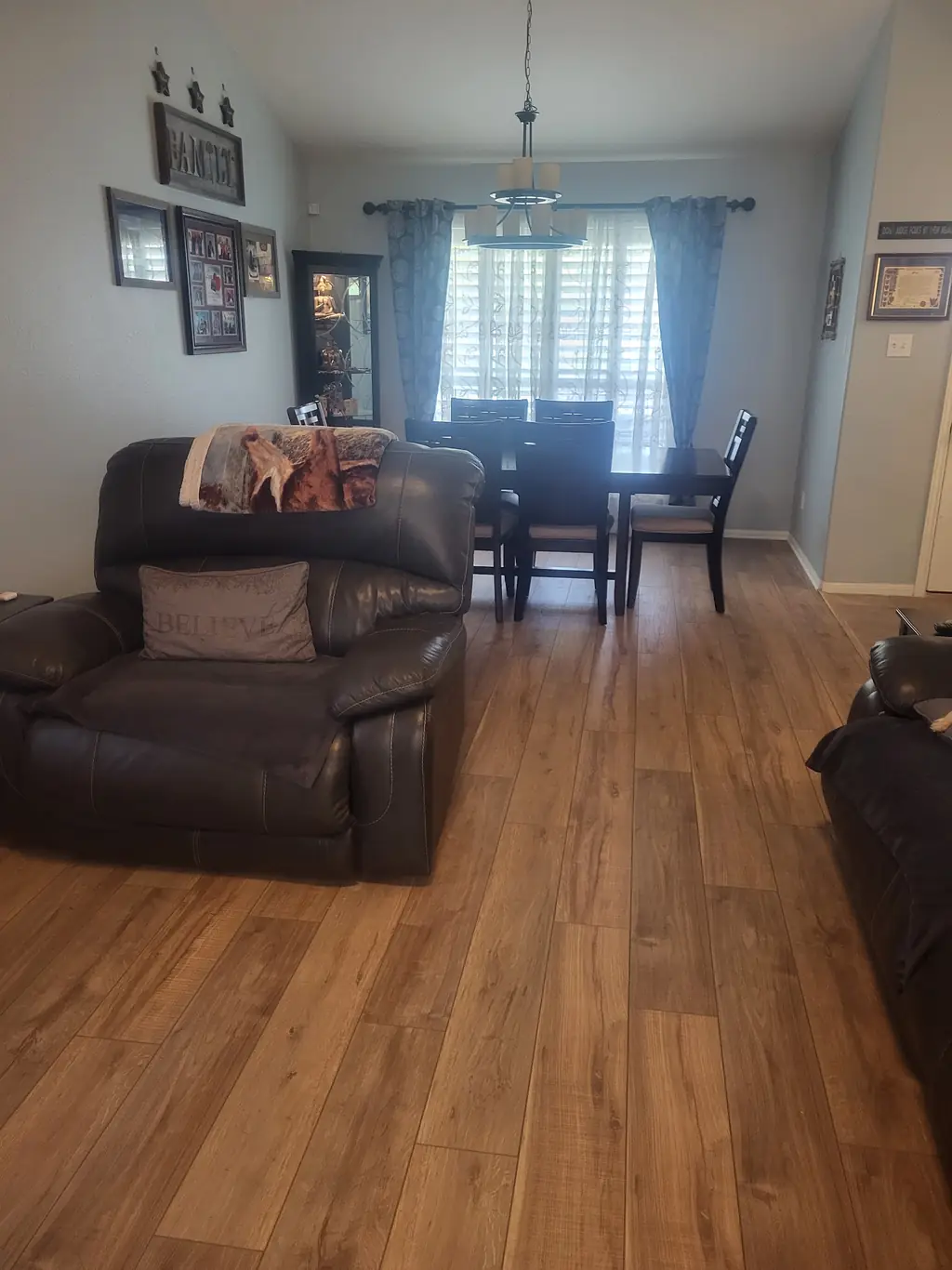 Living and dining room in warm laminate flooring, photographed at floor level